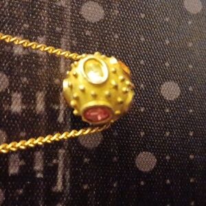 Elegant Gold Toned Necklace with Rolling Sphere Colorful Gemstone Pendant